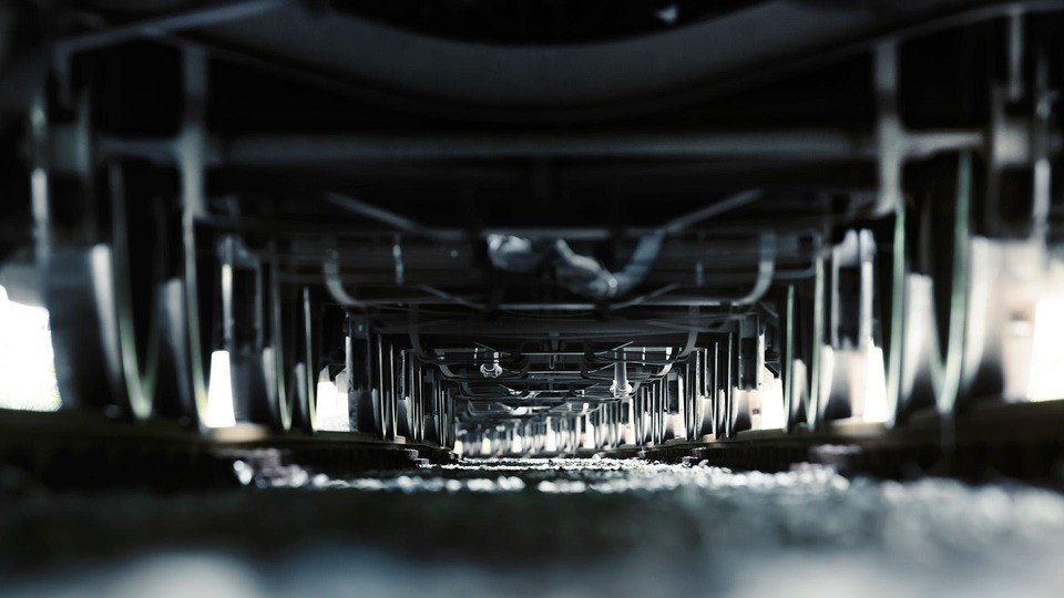 Low-angle view of train wheels and axles on railway tracks