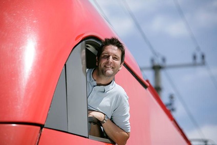 Train driver leaning out of a locomotive cab window