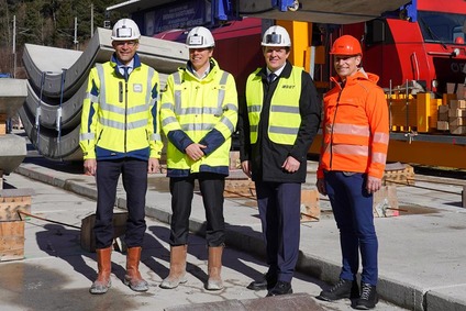Vertreter auf einer Baustelle für Bahninfrastruktur mit Schutzhelmen und Warnwesten