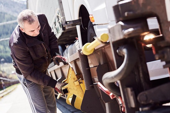 The driver attaches wedges to the car
