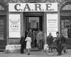 Historisches Bild eines CARE Ladens mit Personen, die in einer Schlange angestellt sind