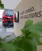 Messestand der Rail Cargo Group auf der Transport Logistic mit roter Lok und Slogan „Your cargo. Our solutions