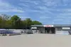 Warehouse Novi Zagreb with exterior view, stacked metal racks, and forklifts in front of the building