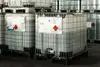 IBC containers with hazardous liquid chemicals stored on pallets in a warehouse