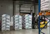 Worker with pallet truck moving pallets in Rail Cargo Group warehouse in Hungary