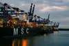 Container ships and cranes at port symbolising sea freight transport