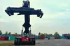 Container handling vehicle lifting equipment in a container yard.