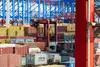 Container terminal with colourful containers and cranes in operation.