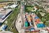 Aerial view of the Sládkovičovo container terminal with stacked containers, rail tracks, and adjacent town area