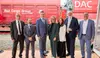 Participants at the DAK event in front of Rail Cargo Group freight wagons and the Digital Automatic Coupling display.