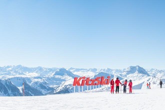 Familie vor dem Logo KitzSki