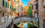 Narrow canal with bridge in Venice Italy Architecture and landmark of Venic Cozy cityscape of Venice