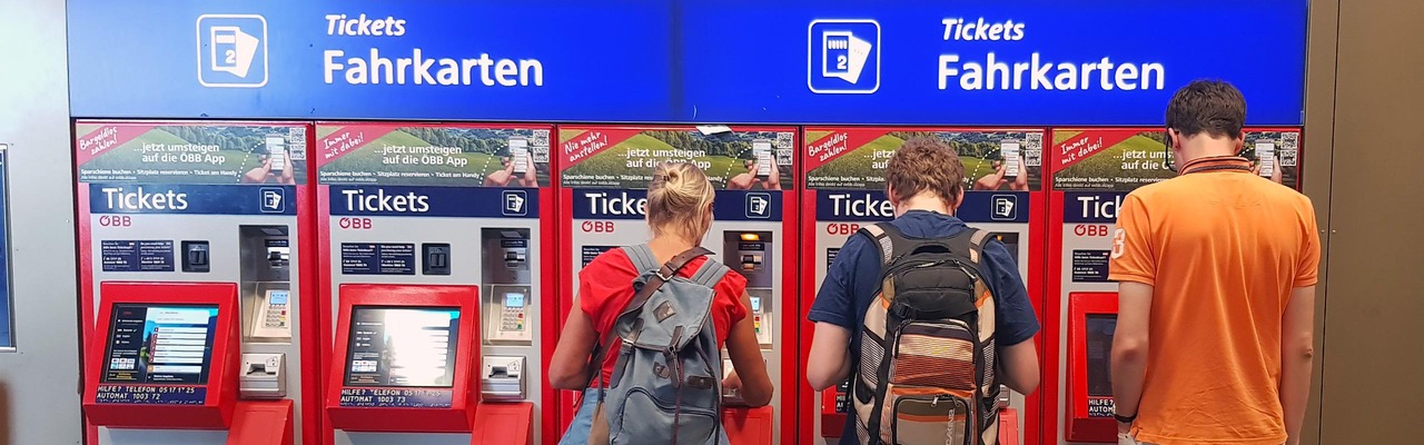 People stand in front of ticket machines